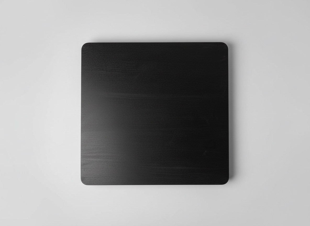 Black metal sheet on a textured gray surface