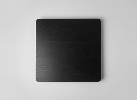 Black metal sheet on a textured gray surface