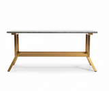 Table with a metallic frame and stone-like top on a dark background