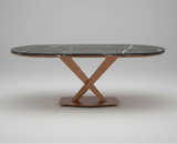 Dining table with marble-like top and metal base in a warehouse setting