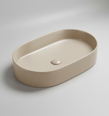 Beige oval ceramic sink on a white background