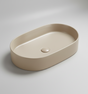 Beige oval ceramic sink on a white background