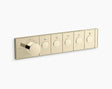 Gold shower control panel with five circular buttons on a white background